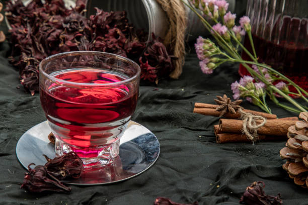 istock Roselle tea (Jamaica sorrel, Rozelle or hibiscus sabdariffa ) with dry roselle and brown cane sugar cube. 1207154021