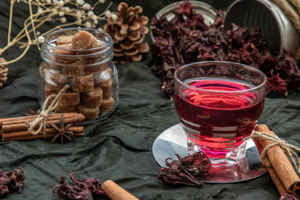 istock Roselle tea (Jamaica sorrel, Rozelle or hibiscus sabdariffa ) with dry roselle and brown cane sugar cube. 1207154024