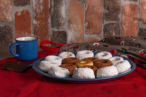 presentation of a plate of donuts served with hot chocolate on a red tablecloth