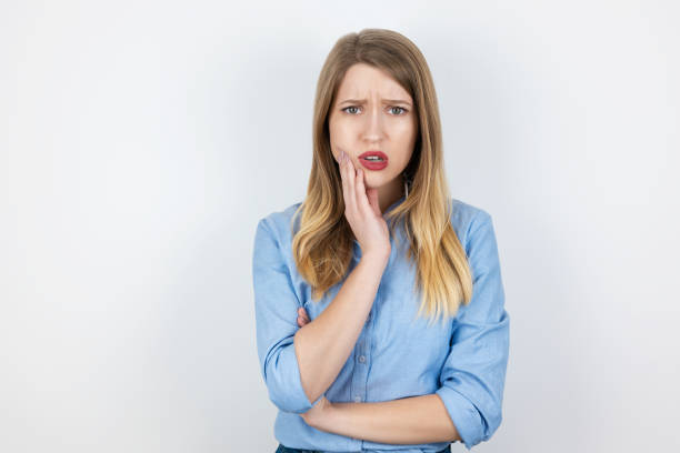 istock young beatuiful blond woman standing on isolated white background suffering from sudden toothache, healthcare and medical concept 1207155531
