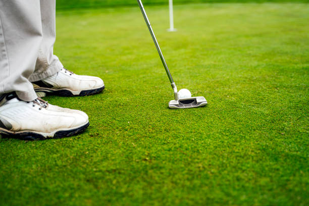 istock senior person putting on the green on a golf course 1207156390