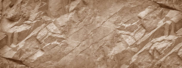 Stone wall background. Light brown rock texture. Stone grunge backdrop. Rocky texture banner with copy space for your design. natural granite rough stone stock pictures, royalty-free photos & images