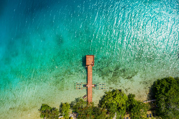Paradise wooden beach path from a top aerial view stock photo