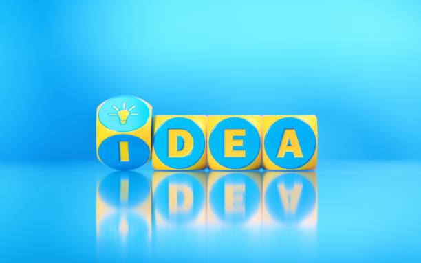istock Idea Written on Yellow Cubes Turning on Reflective Blue Background 1207163541
