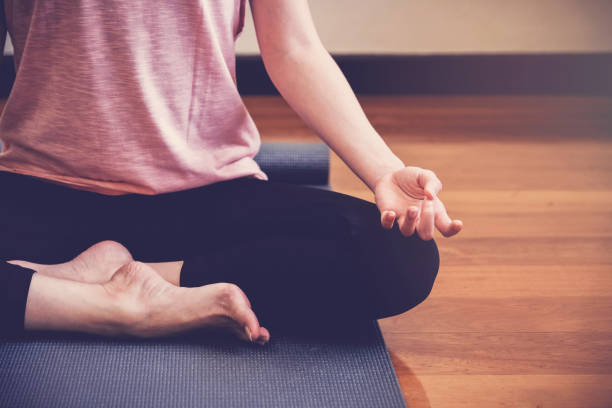 istock young healthy woman practicing yoga lesson, lotus pose with instructor in home studio, wellness and fitness lifestyle concept, new year 2020 healthy resolution 1207164764