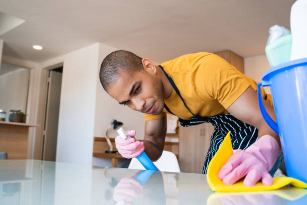 istock Young latin man cleaning at home. 1207167119