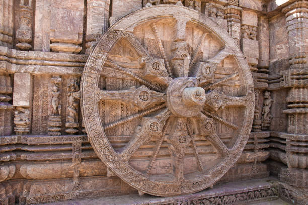 Ancient sandstone carved chariot wheel on Konark sun temple Ancient sandstone carved chariot wheel on Konark sun temple in Odisha, India chariot wheel at konark sun temple india stock pictures, royalty-free photos & images