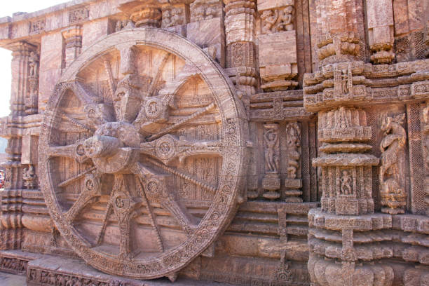 istock Ancient sandstone carved chariot wheel on Konark sun temple 1207171731