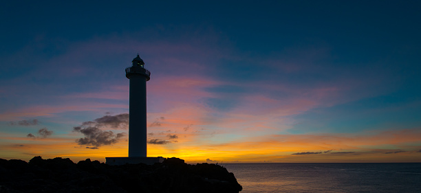 Lighthouse at cape Zanpa Okinawa Japan silhouetted at sunset