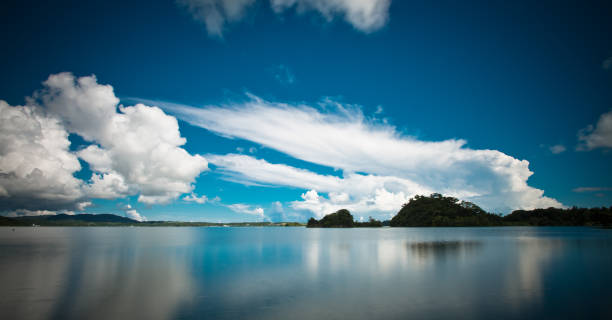 istock Clouds over perfectly calm water reflections Okinawa Japan 1207172015