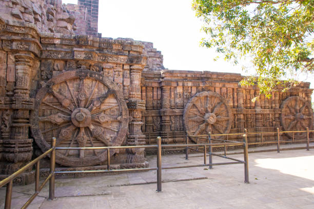 Ancient sandstone carved chariot wheel on Konark sun temple Ancient sandstone carved chariot wheel on Konark sun temple in Odisha, India chariot wheel at konark sun temple india stock pictures, royalty-free photos & images
