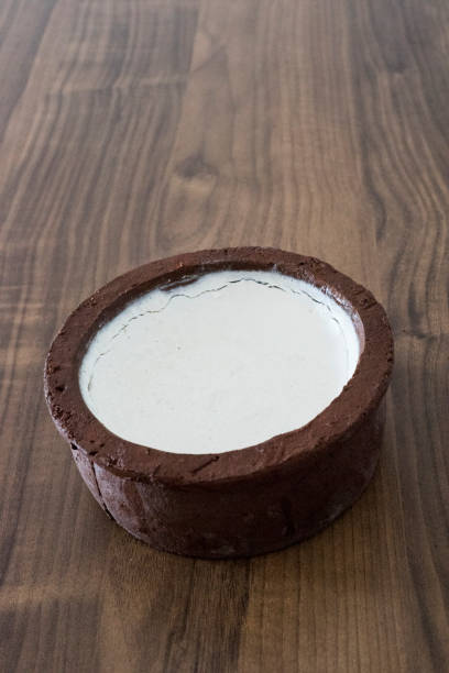istock Buffalo Curd in an earth pot on a wooden brown table 1207177837