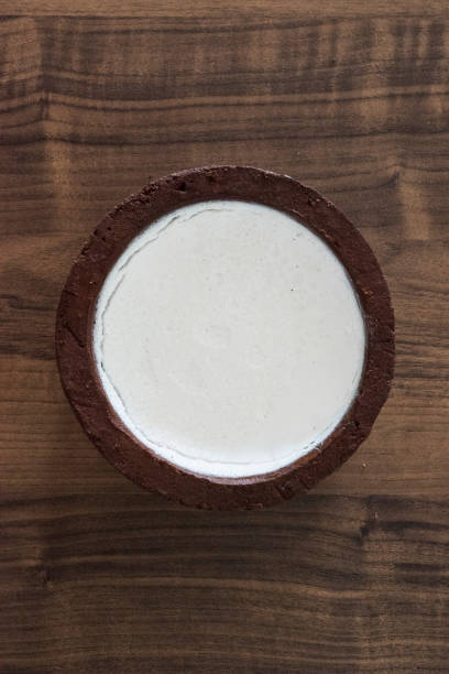 istock Buffalo Curd in an earth pot on a wooden brown table 1207177841