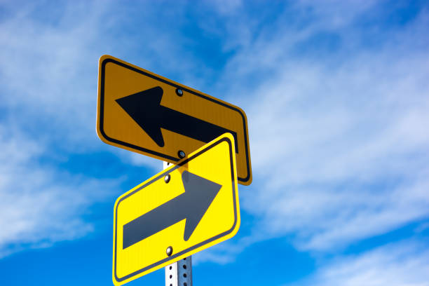 istock Two Yellow Directional Signs with Arrows 1207178895