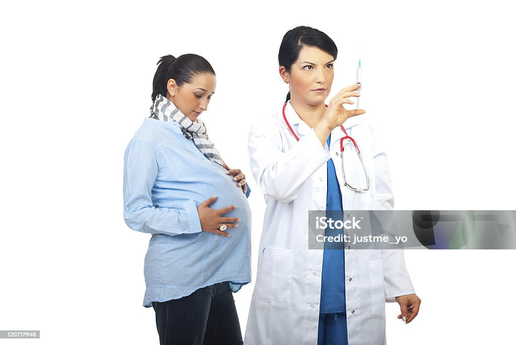 Doctor prepare vaccine for pregnant Serious doctor woman prepare a syringe with vaccine for  pregnant Adult Stock Photo