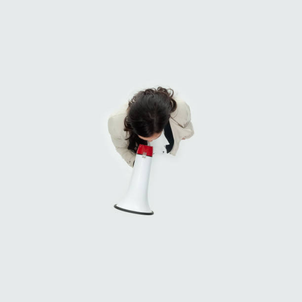 caucasian mid adult women business person standing in front of white background in the office wearing businesswear and holding megaphone - 13571 imagens e fotografias de stock