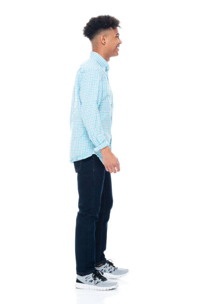istock Generation z male standing in front of white background wearing button down shirt 1207180716