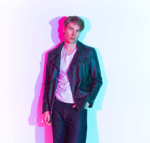 istock Caucasian male in front of colored background wearing leather jacket 1207181711