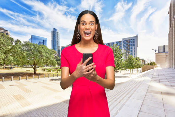 african-american ethnicity young women standing who is outdoors and using smart phone - thank you excitement waist up horizontal imagens e fotografias de stock