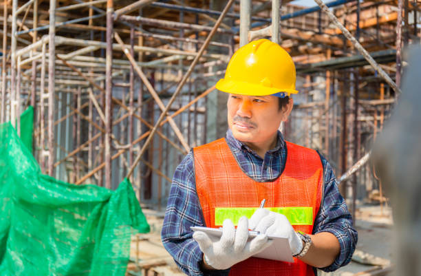 istock Engineer man checking and planning project at construction site, Man holding clipboard checklist over blue background 1207183652