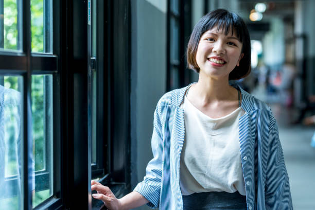 istock Female student by the window 1207188310