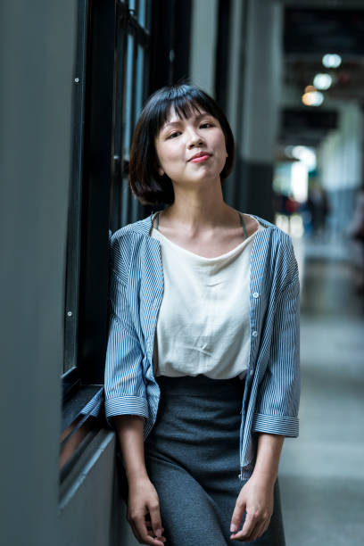 istock Female student by the window 1207188359