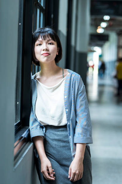 istock Female student by the window 1207188360