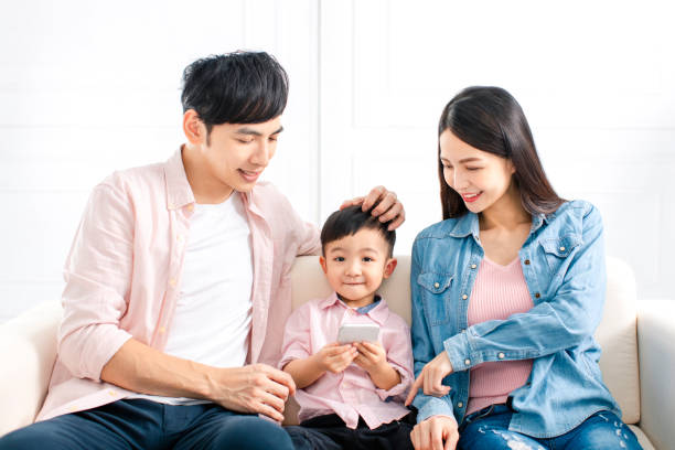 istock happy family watching the smart phone  on sofa 1207193701