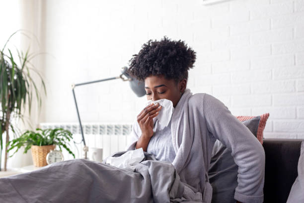 istock Woman lying in bed with virus and high temperature 1207197801