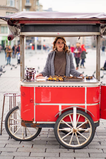 istock girl on a tray with roasted chestnuts 1207197904