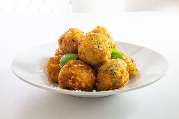 Deep Fried Risotto Balls Deep Fried Risotto Balls with basil auriculariales photos stock pictures, royalty-free photos & images