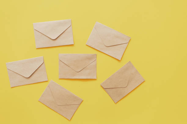istock Brown paper envelope on yellow pastel abstract background. 1207199237