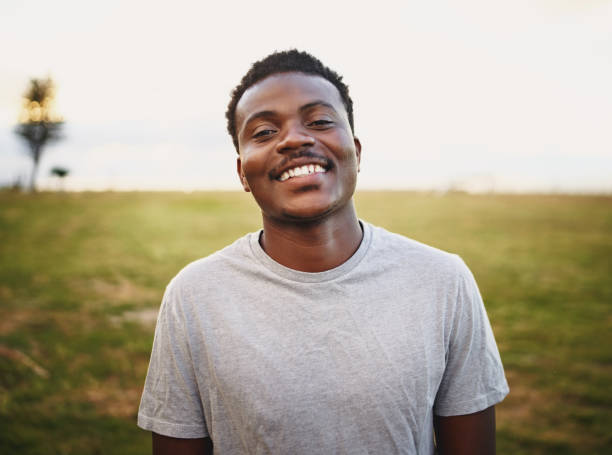istock Happy young male athlete smiling and looking at camera at park 1207199664