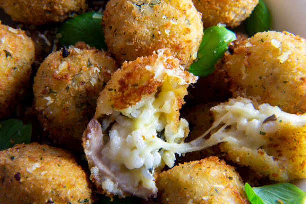 Deep Fried Risotto Balls Deep Fried Risotto Balls with basil auriculariales photos stock pictures, royalty-free photos & images