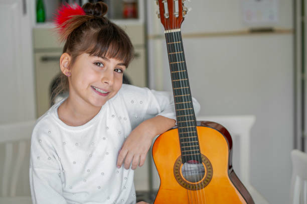 istock Cute girl playing guitar 1207203345