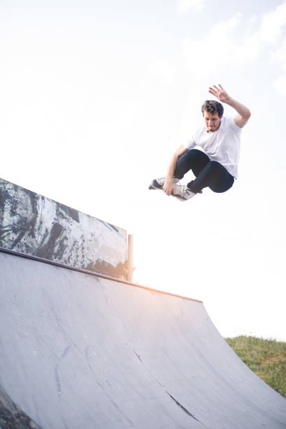 istock man roller skating on rollers makes a trick jump from the pedestal 1207204939
