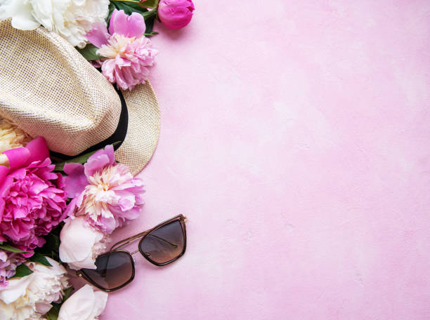 istock Pink peonies and hat on a pink concrete background 1207205178
