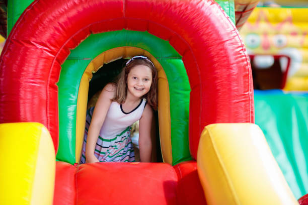 istock Child jumping on playground trampoline. Kids jump. 1207210475