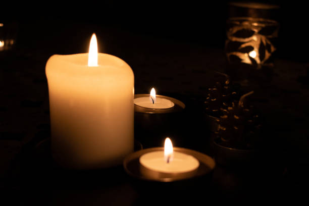 istock Candles burning in the dark 1207210563