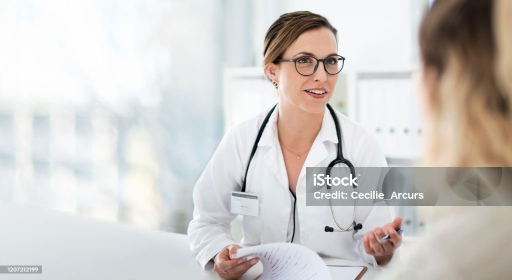 You're well on your way back to full health Cropped shot of an attractive young female doctor consulting with a patient inside her office at a hospital Doctor Stock Photo