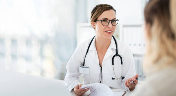You're well on your way back to full health Cropped shot of an attractive young female doctor consulting with a patient inside her office at a hospital doctor patient stock pictures, royalty-free photos & images