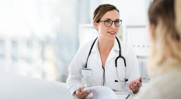 You're well on your way back to full health Cropped shot of an attractive young female doctor consulting with a patient inside her office at a hospital general practitioner stock pictures, royalty-free photos & images