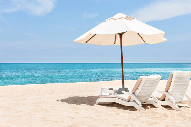 istock Beach chairs and umbrellas on the sand near water side 1207213895