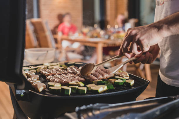 istock Hands of a man seen flipping cevapcici 1207215534