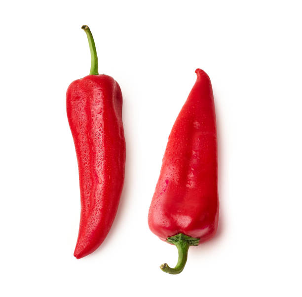 istock Two whole red bell peppers isolated on white background 1207215710
