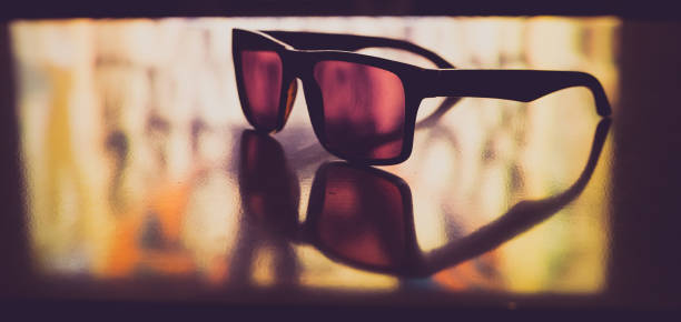 istock Sunglasses on a colorful reflective background 1207216031