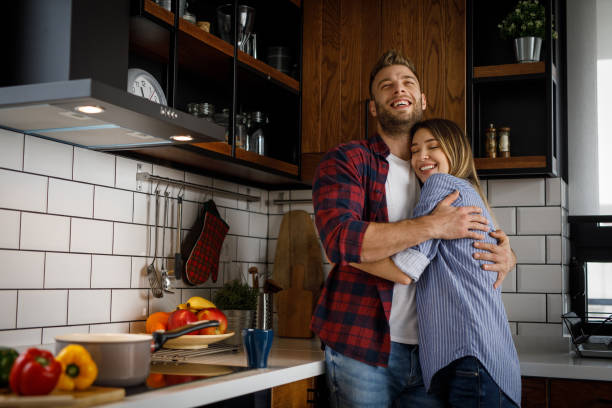 istock Happy young couple embracing in kitchen 1207217996