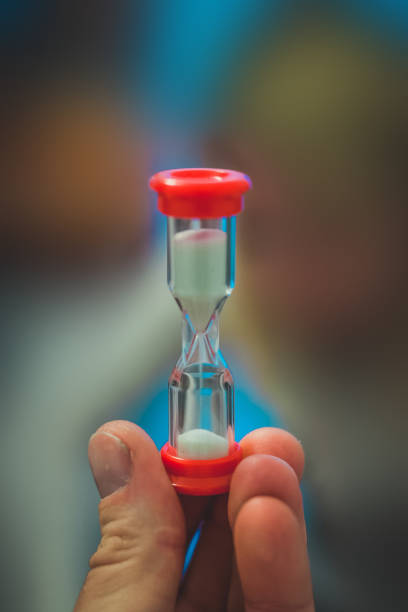 istock Sand clock in a hand of a man. 1207218454