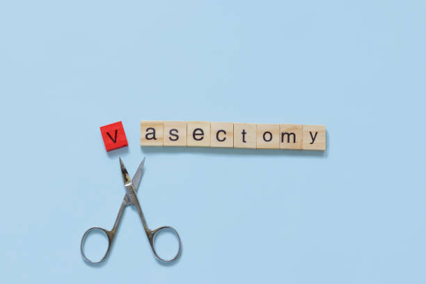 the word vasectomy made with wooden tiles on a blue background; V is red and scissors are under the word male vasectomy concept flat lay style medical procedure stock pictures, royalty-free photos & images