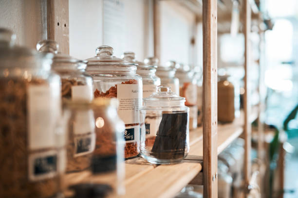 More glass, less plastic pollution Shot of glass jars filled with food on shelves in a waste free store organic spice stock pictures, royalty-free photos & images